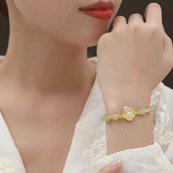 Luxurious White Jade Gold Bracelet with Elegant Flower Charm - Image 5